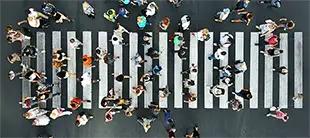 Aerial view of diverse pedestrians crossing a street, representing the Cultural Awareness for Global Business course