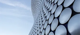 Curved building facade with circular patterns, representing the Circular Economy course