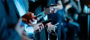 People using connected mobile devices, representing the Industrial Internet of Things course