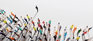Group of people following a person walking ahead